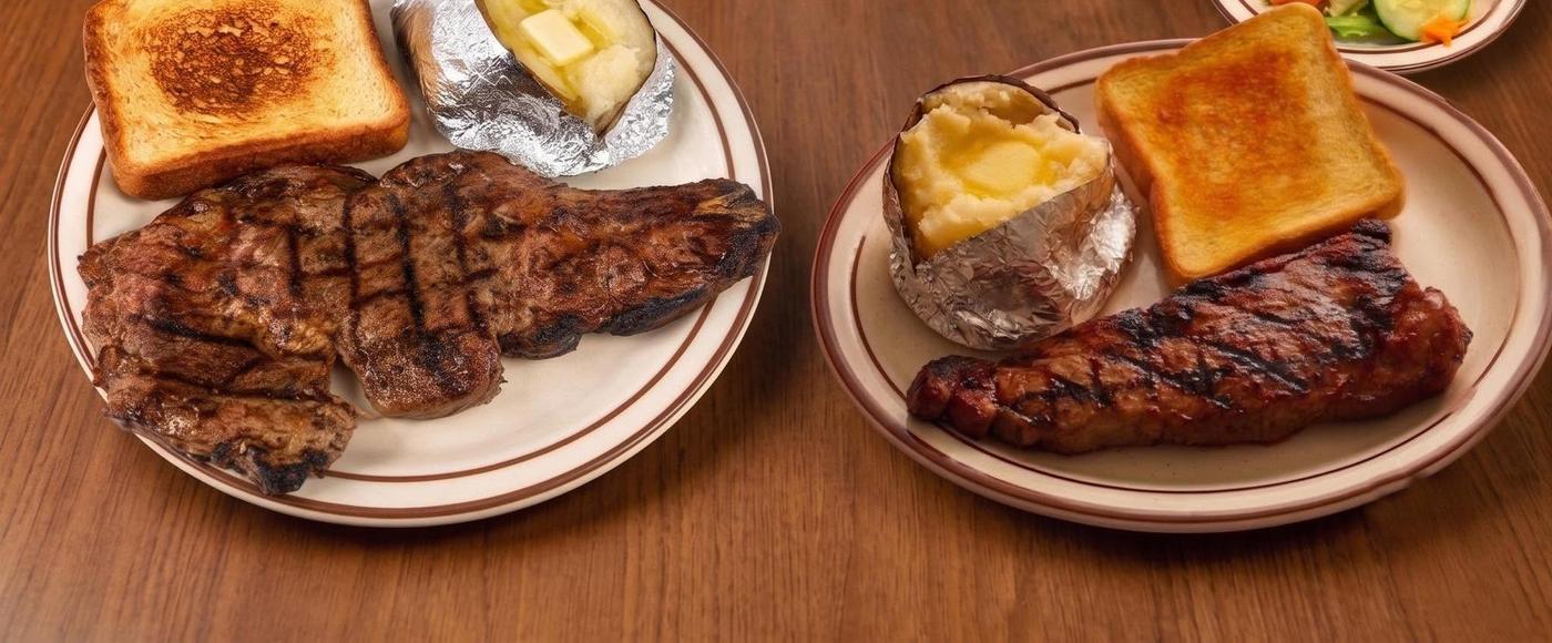 Two grilled steak plates with baked potato, toast, and salad at Grecian Steak House